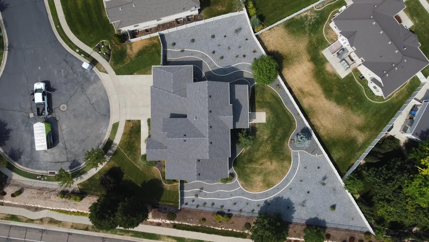 Overhead view of the converted South Ogden yard showing concrete-edged paths, planting islands, and the lawn area kept near the house
